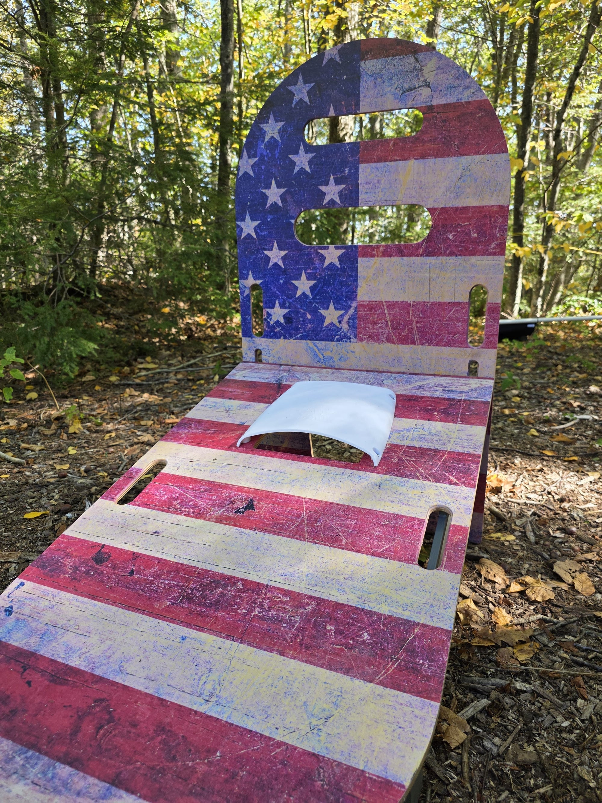 Close-up of SlotShot game board with American flag pattern and scoop opening